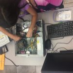 A student tries their hand at replacing RAM.