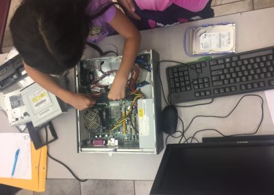 A student tries their hand at replacing RAM.