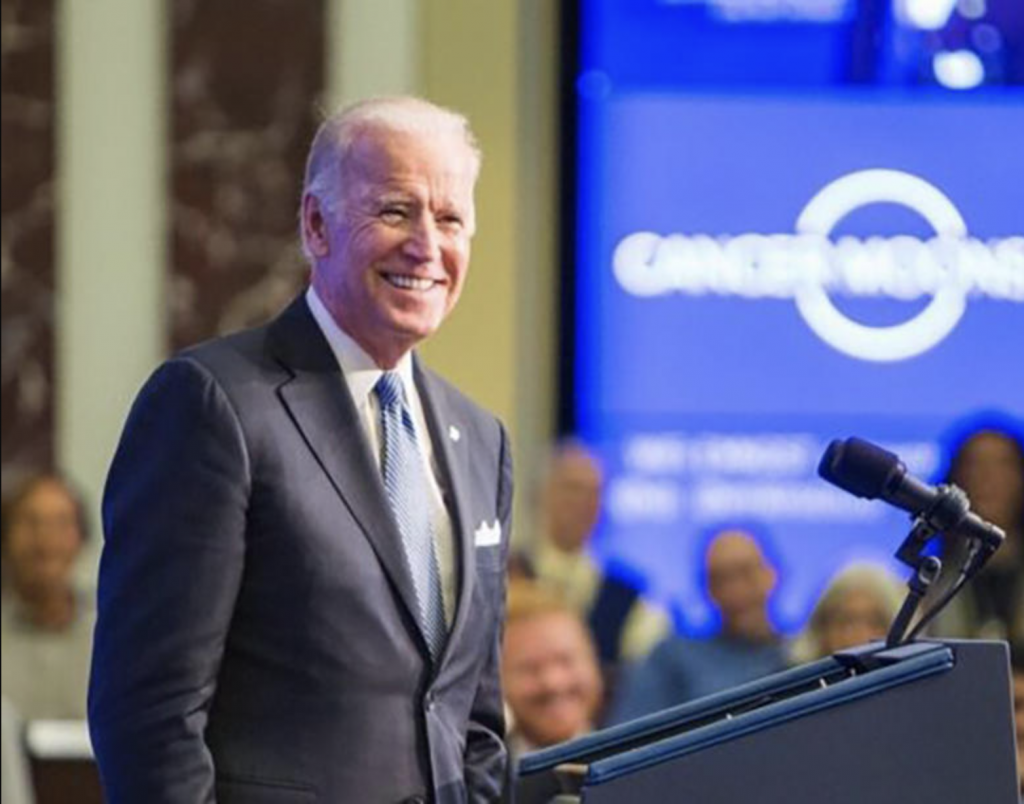 President Joe Biden smiles in front of a crowd