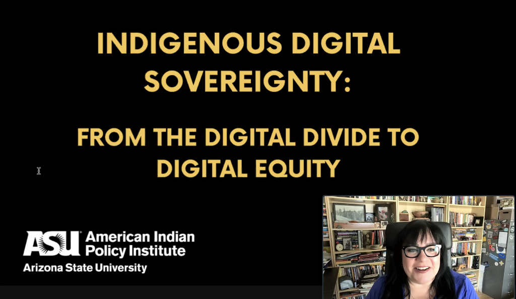 Screenshot of slide with black background and yellow text: Indigenous Digital Sovereignty: From the Digital Divide to Digital Equity. In the right bottom corner, there is a picture of a woman with black hair and a blue dress with books in the background
