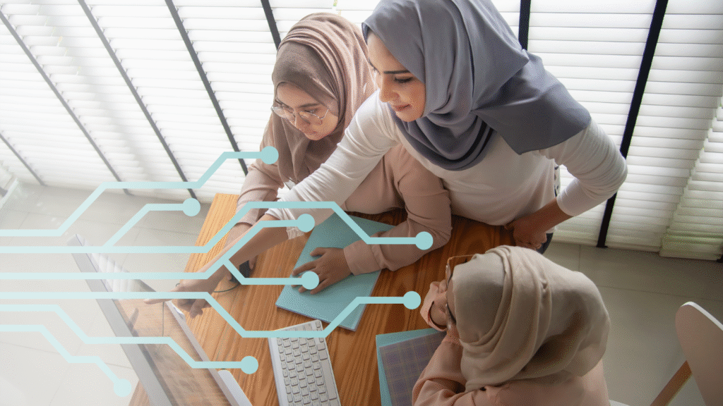 Three women are gathered around a computer, with one of them showing the other two something on the screen. An design resembling a circuit board is overlaid on top.
